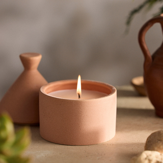 candle set in a terracotta pot with matching lid
