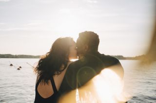 Couple kissing at sunset