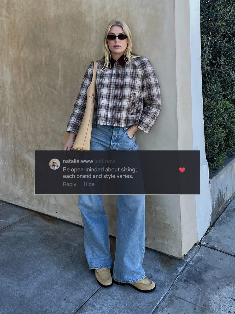 who what wear editor wearing denim posing outdoors in front of a wall