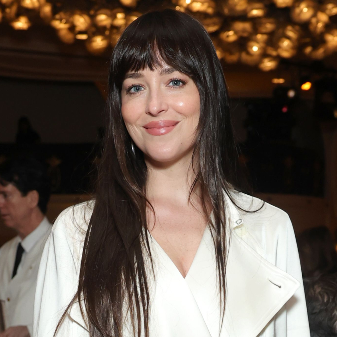 Dakota Johnson delivered holiday party dressing inspiration in a white satin trench coat
