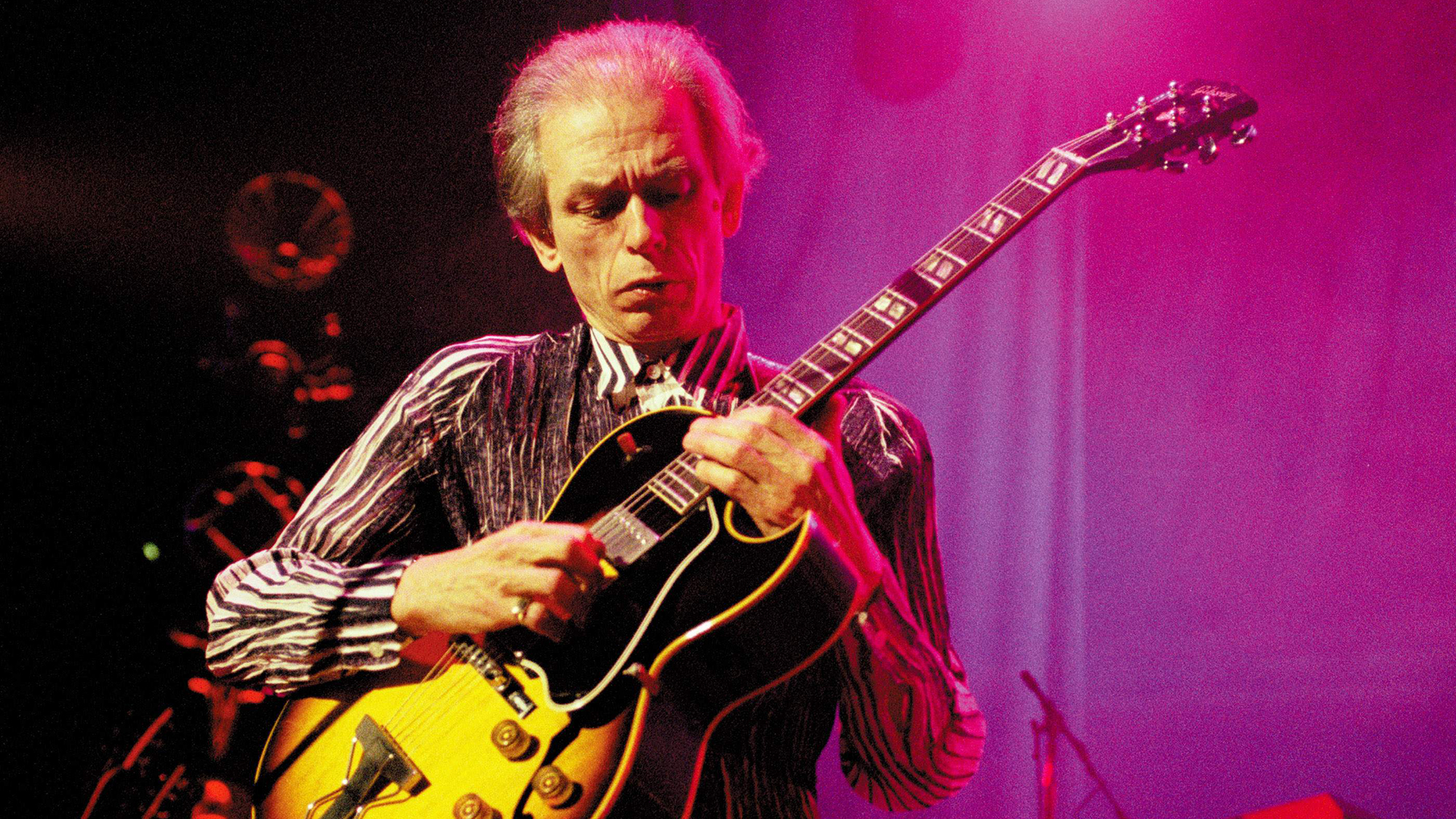 Steve Howe performs onstage with Yes, playing Gibson ES-175 guitar