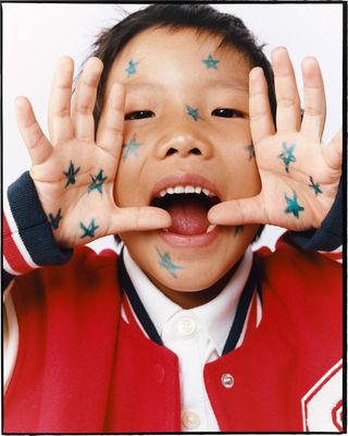 Young happy boy with stars drawn on his face, from Zara Beauty Mini Artists makeup for kids range
