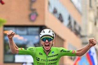 Tadej Pogačar celebrates taking gold in the elite men's road race