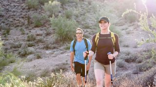 Two hikers hiking in the desert