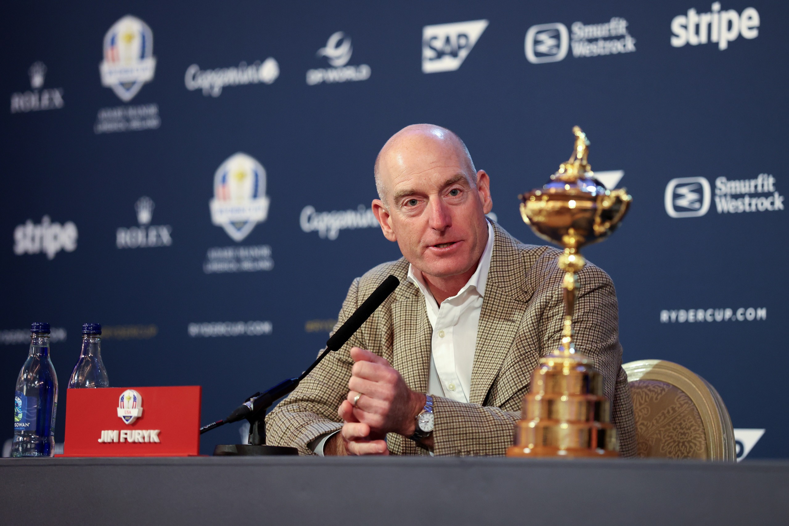 Jim Furyk speaks in front of the Ryder Cup trophy at a press conference