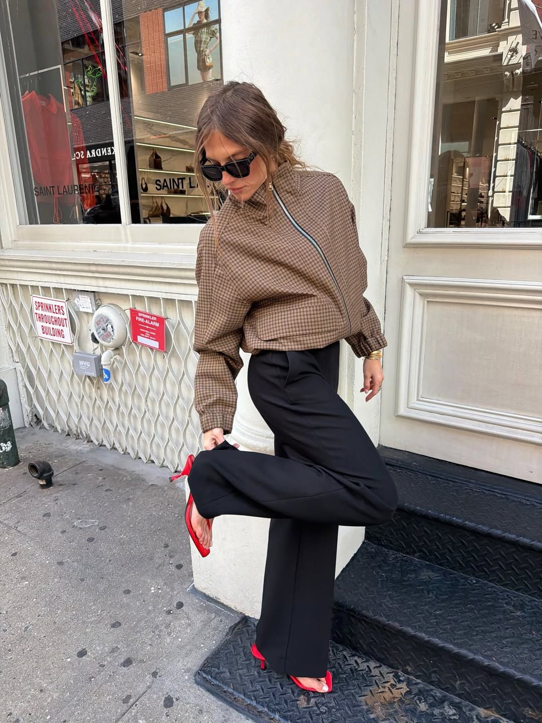 hannah lovey wears a check jacket, black trousers and red flip flop heels: best bottoms to wear with flip flop heels 2026