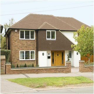 house exterior with brick wall and plant