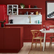 Kitchen with red walls, counters and fridge