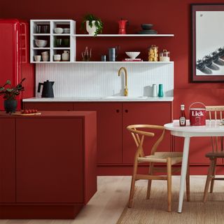 Kitchen with red walls, counters and fridge