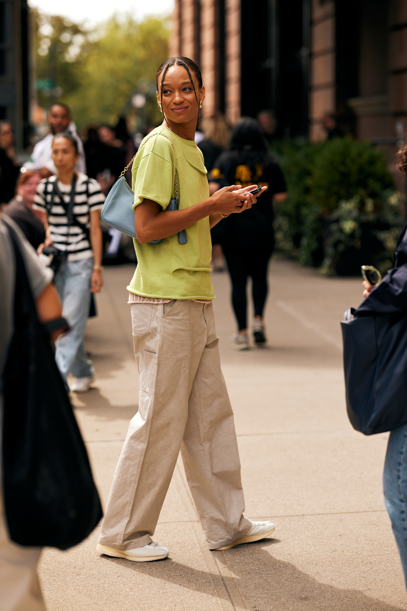 woman wearing green top and khaki pants