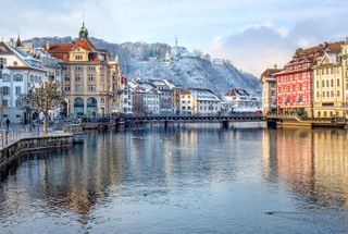 Lucerne, Switzerland, on an overcast day with snow on the mountains in the background