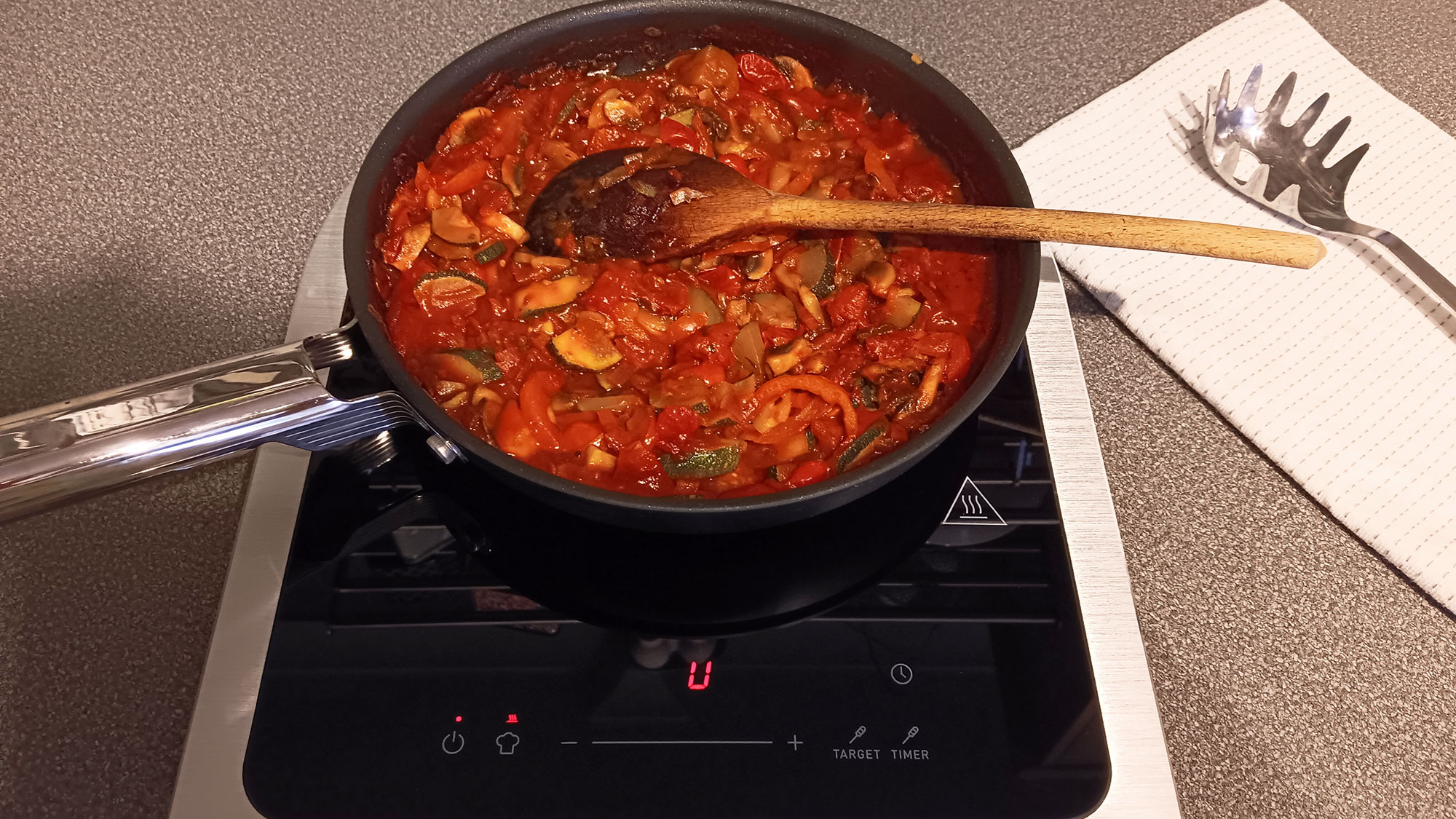 Vegetable sauce cooking on Smeg Portable Induction Cooktops