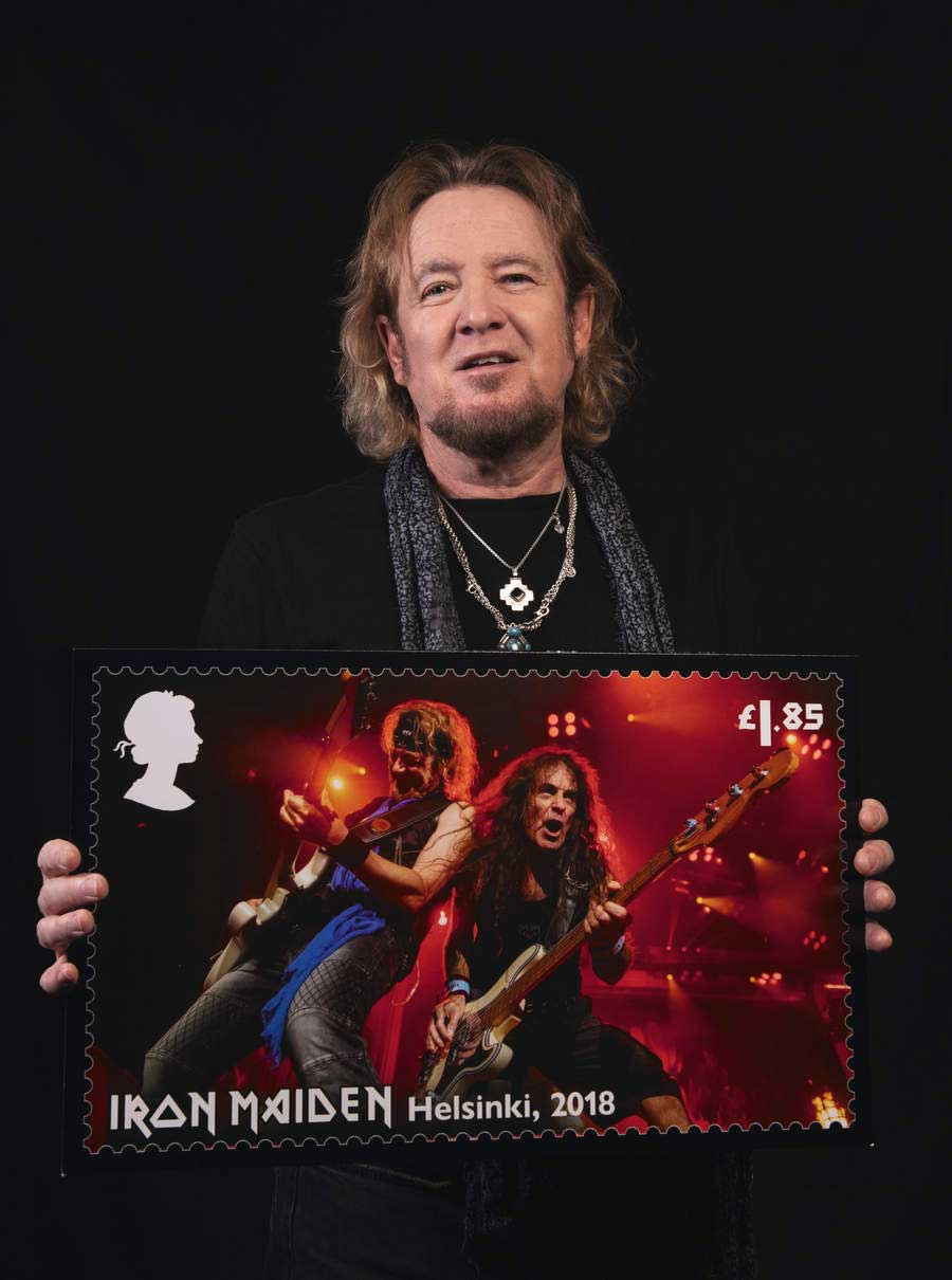 Adrian Smith holding a stamp mock-up