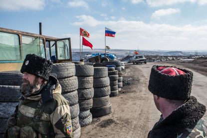 Pro-Russia Cossack rebels guard a checkpoint in Perevalsk, Ukraine