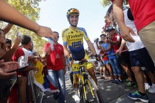 Alberto Contador makes his way through the fans at the start