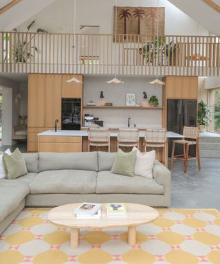 modern vaulted ceiling living room with a open plan space wooden kitchen corner sofa and a yellow rug