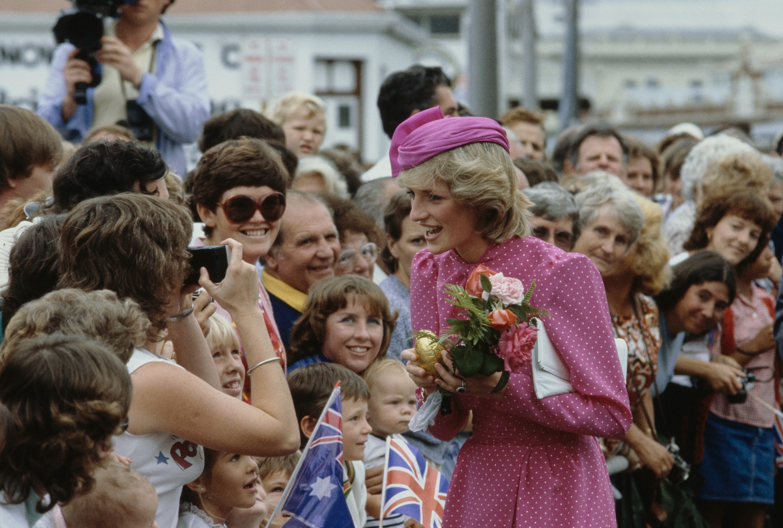 Princess Diana talking to fans in a pink dress