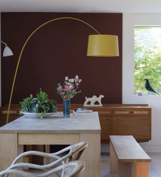 Home office in dining area painted deep reddish brown