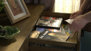 Scarlett Butcher hides a photo in a Die Hard DVD case