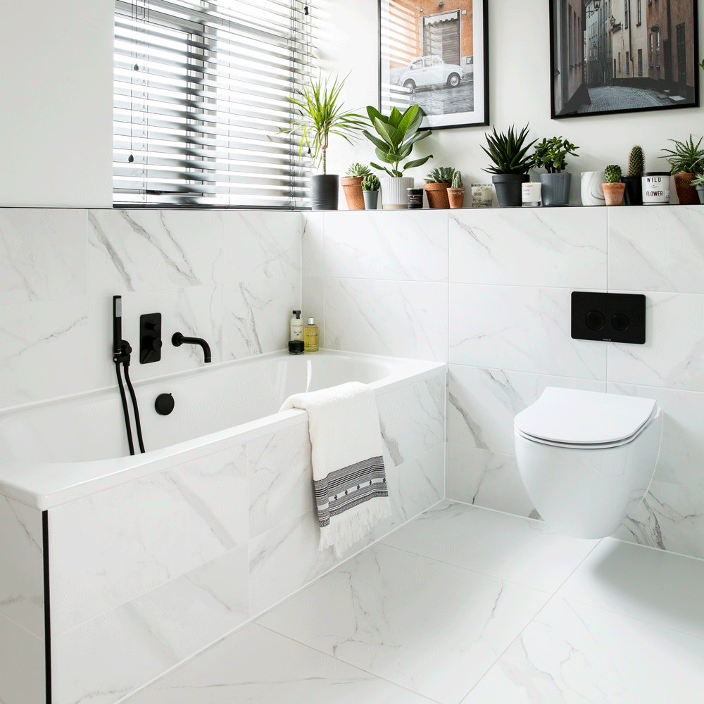 bathroom with white tiled walls and white bathtub