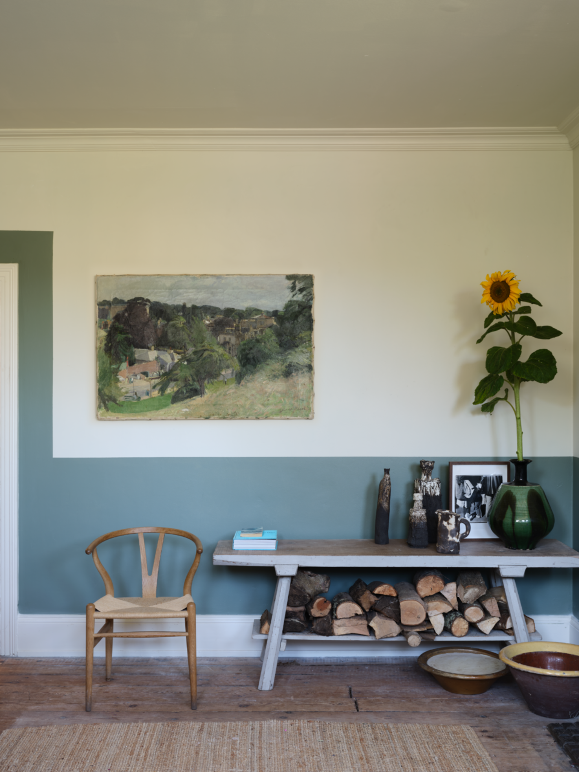 A living area with two-tone walls, with the lower portion of the wall mimicking a dado rail