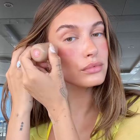 Hailey Bieber applying blush