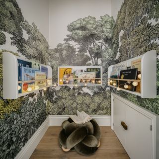 A kids reading nook with a tree wall mural