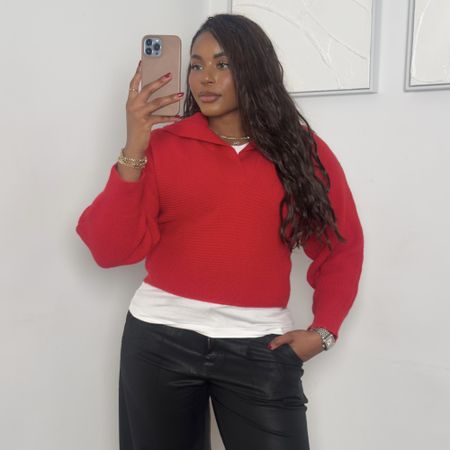 fashion and beauty influencer Kaye Bassey poses in winter 2026 outfit formulas including a red sweater, white T-shirt, and black leather pants