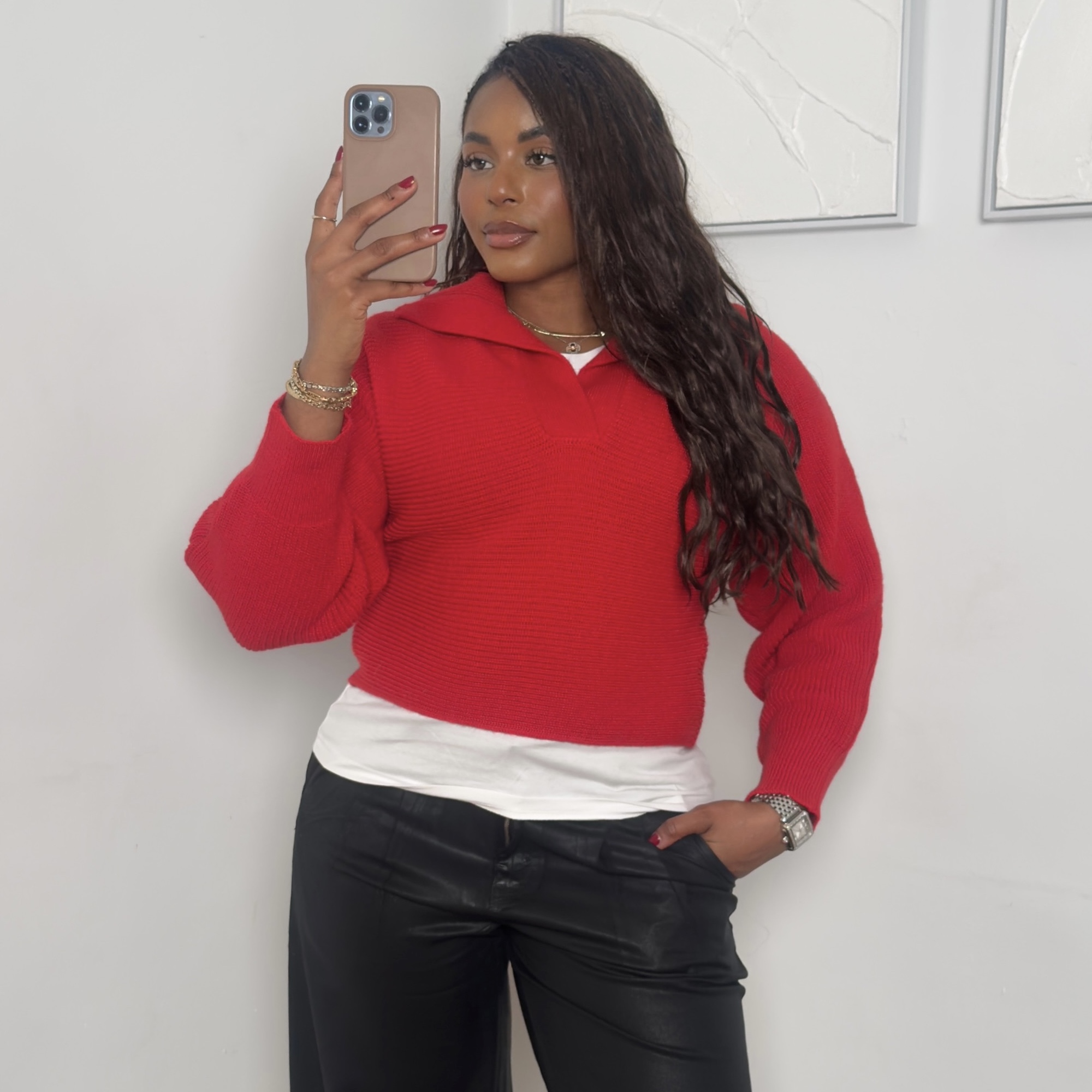 fashion and beauty influencer Kaye Bassey poses in winter 2026 outfit formulas including a red sweater, white T-shirt, and black leather pants