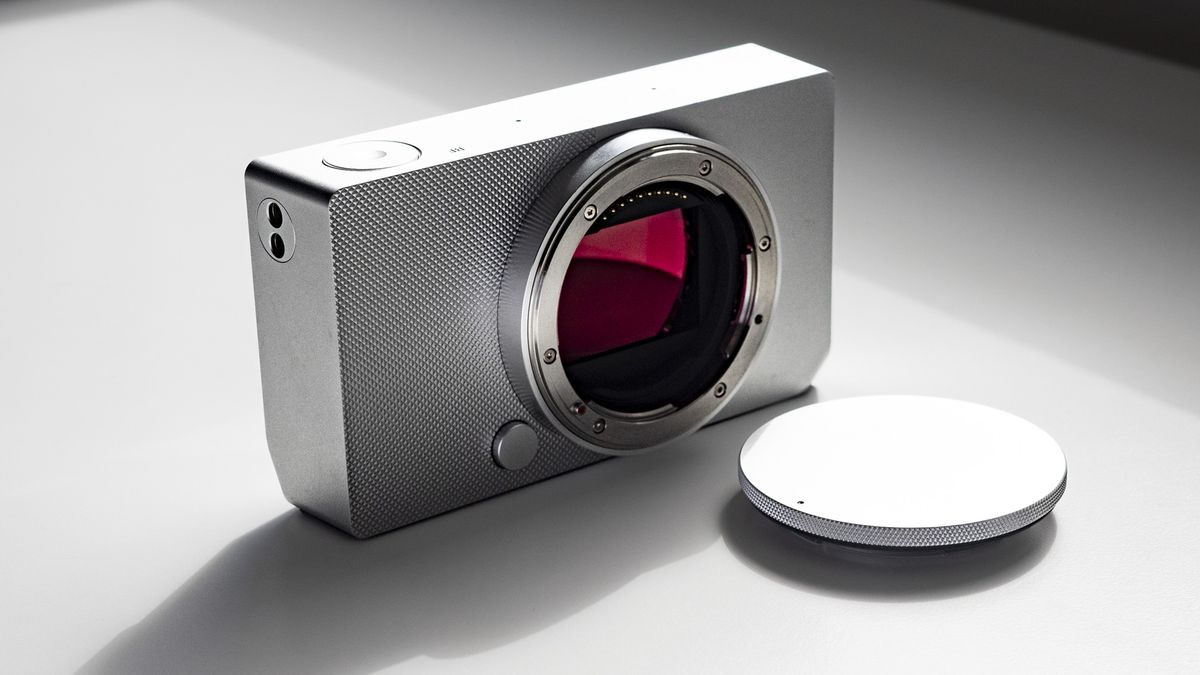 Sigma BF with its body cap, on a white surface in strong light, with defined shadows