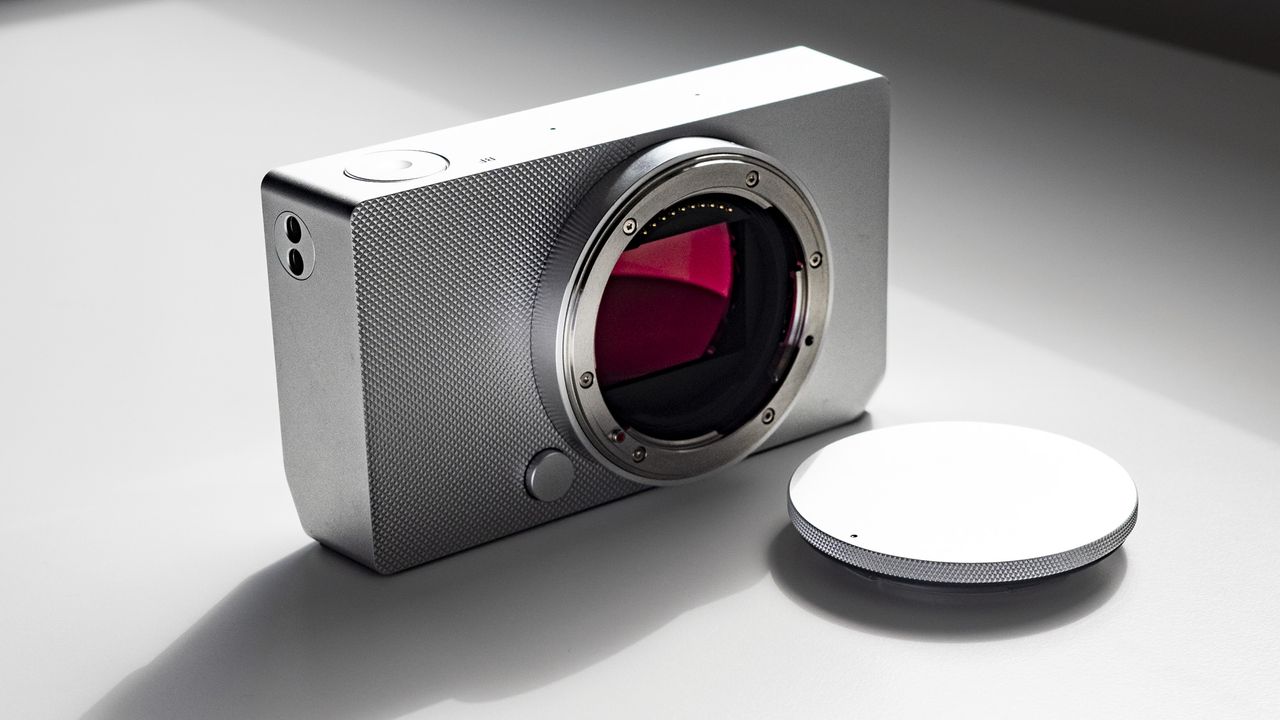 Sigma BF with its body cap, on a white surface in strong light, with defined shadows