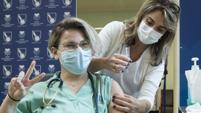 An Israeli medical student receives the Pfizer-BioNTech Covid vaccine