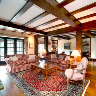 living room with wooden beams and sofa set