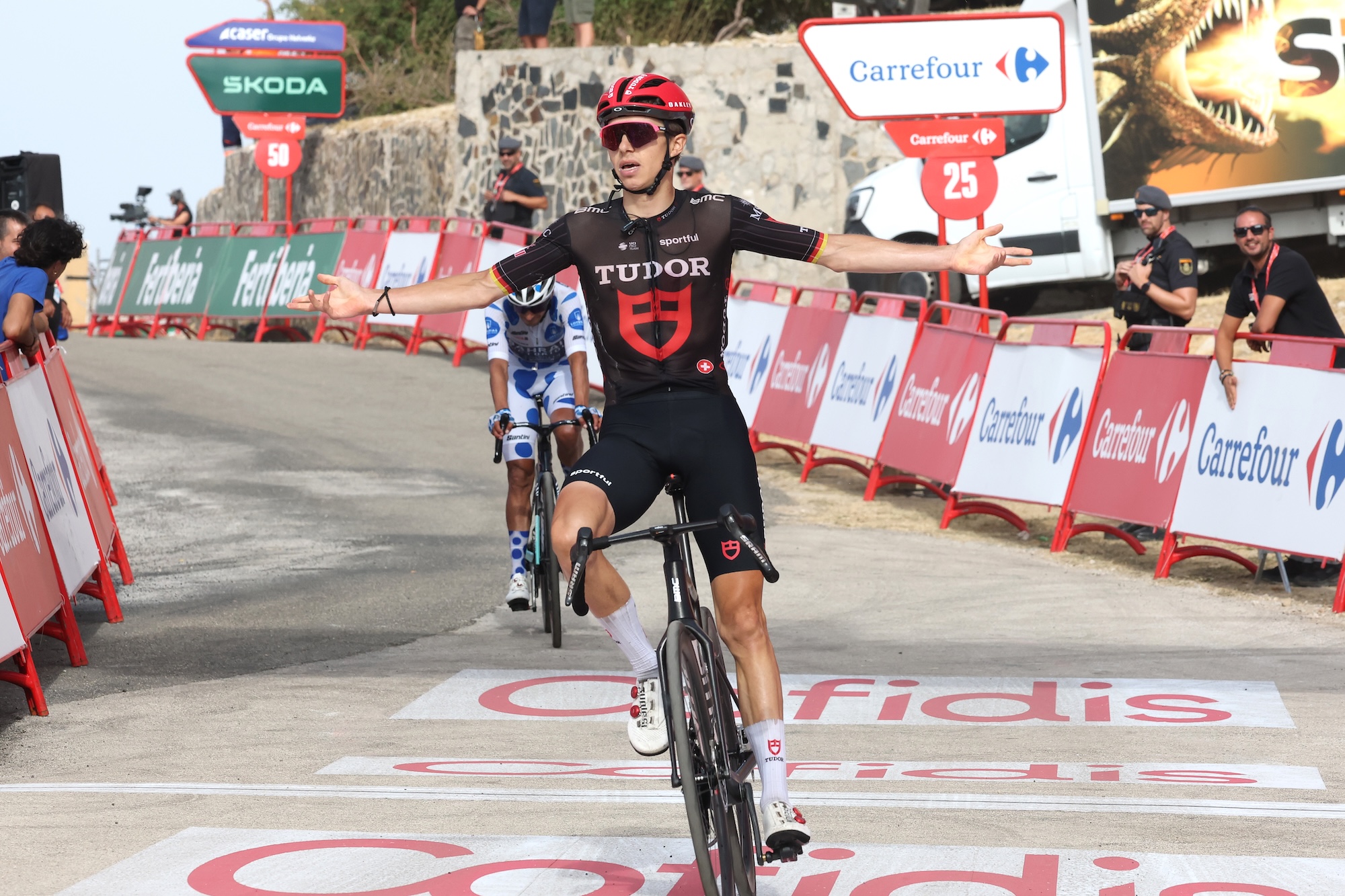 Marco Brenner of Tudor Pro Cycling celebrates at finish line as stage 14 winner
