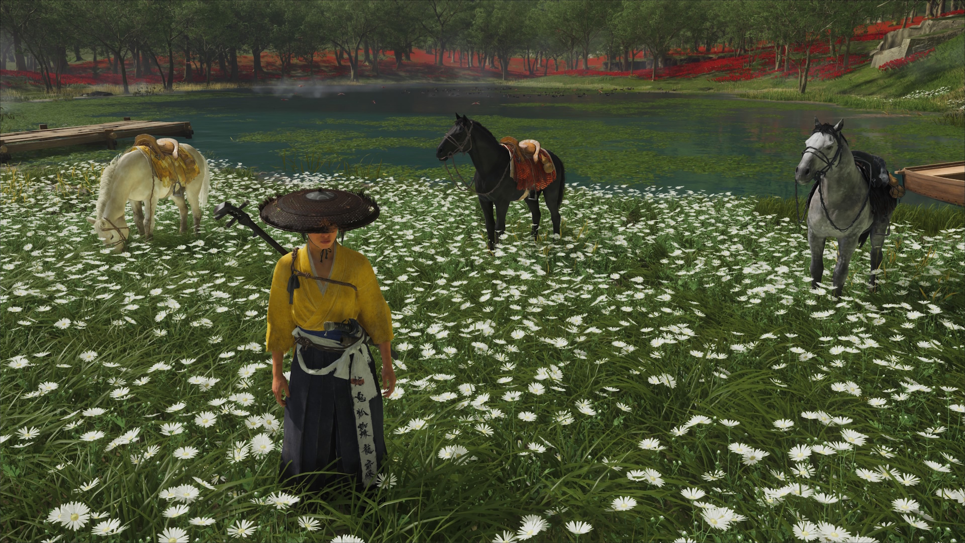 Ghost of Yotei still of Atsu standing in a field of flowers in front of three horses of different colors
