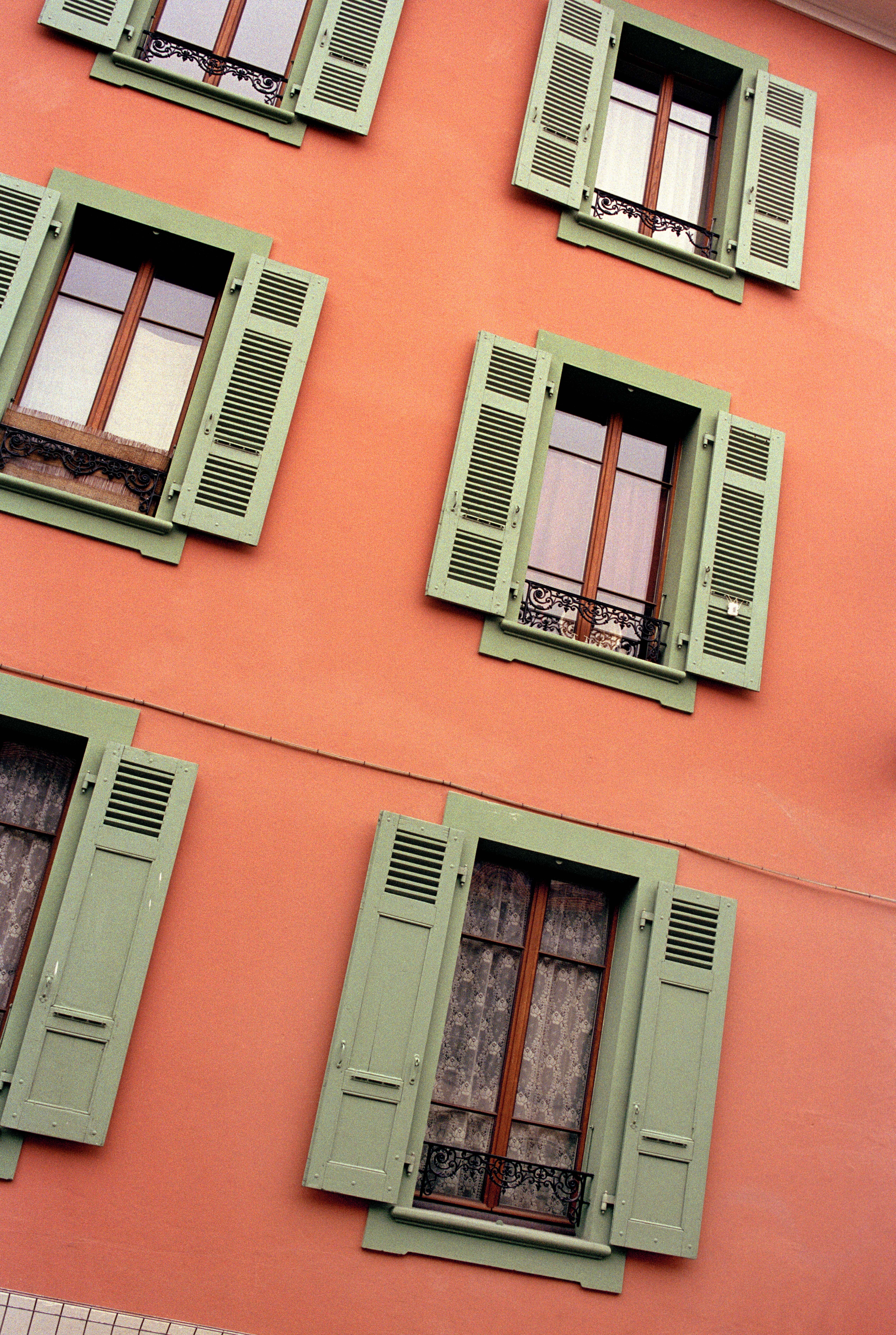 Geneva building with orange painted façade and green shutters