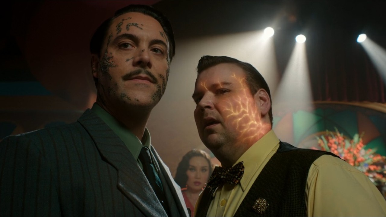 Andrew Lewis Caldwell talking to Jack Huston with Li Jun Li behind in Spider-Noir.