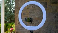 best ring lights for phones: Inkletech 21-inch ring light in front of a wall