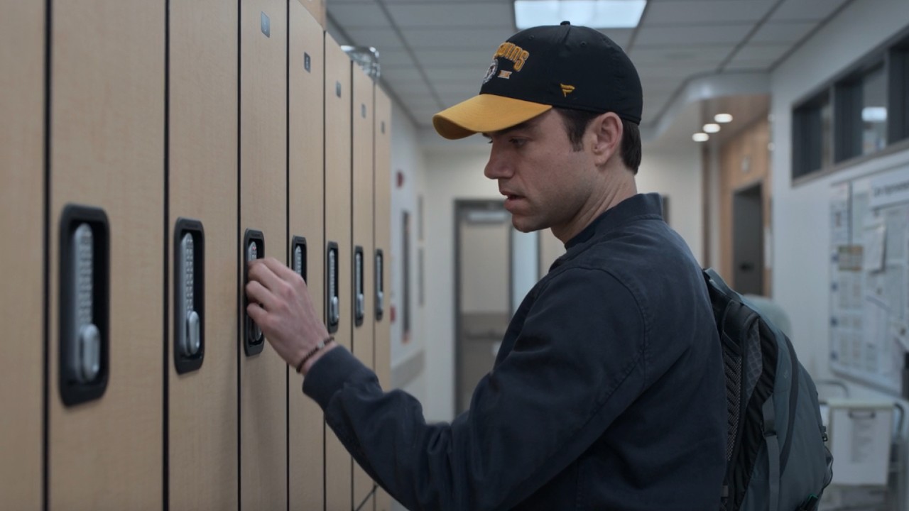 Langdon opening his locker with his left hand, there's no ring on his finger.