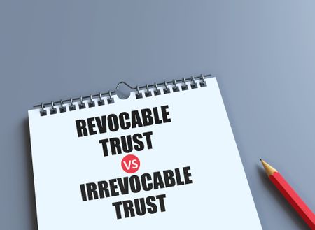 pencil and book with the words Irrevocable Trust vs Revocable Trust