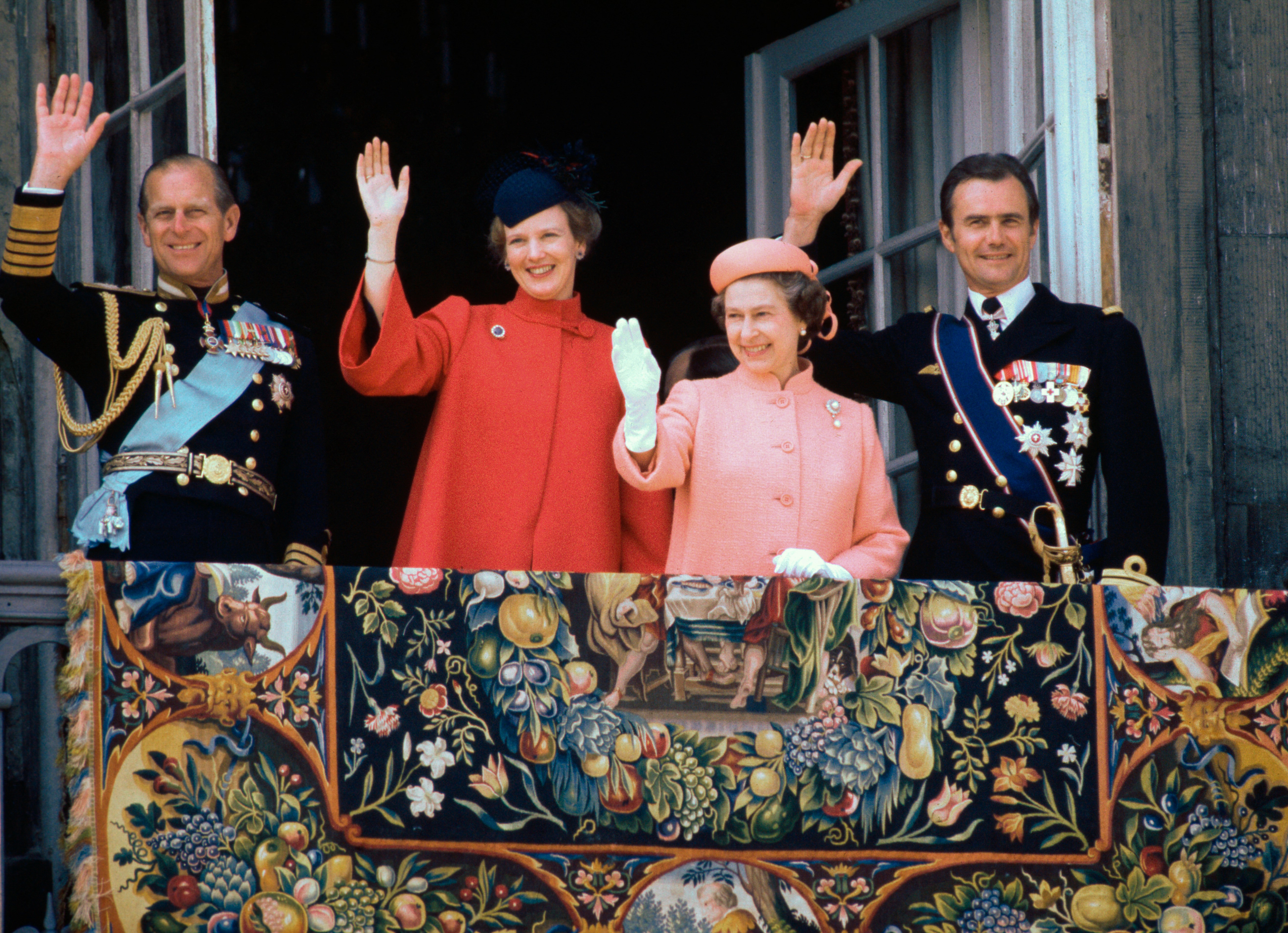 Queen Margrethe, Prince Philip, Queen Elizabeth and Prince Henrik waving from a balcony in 1979