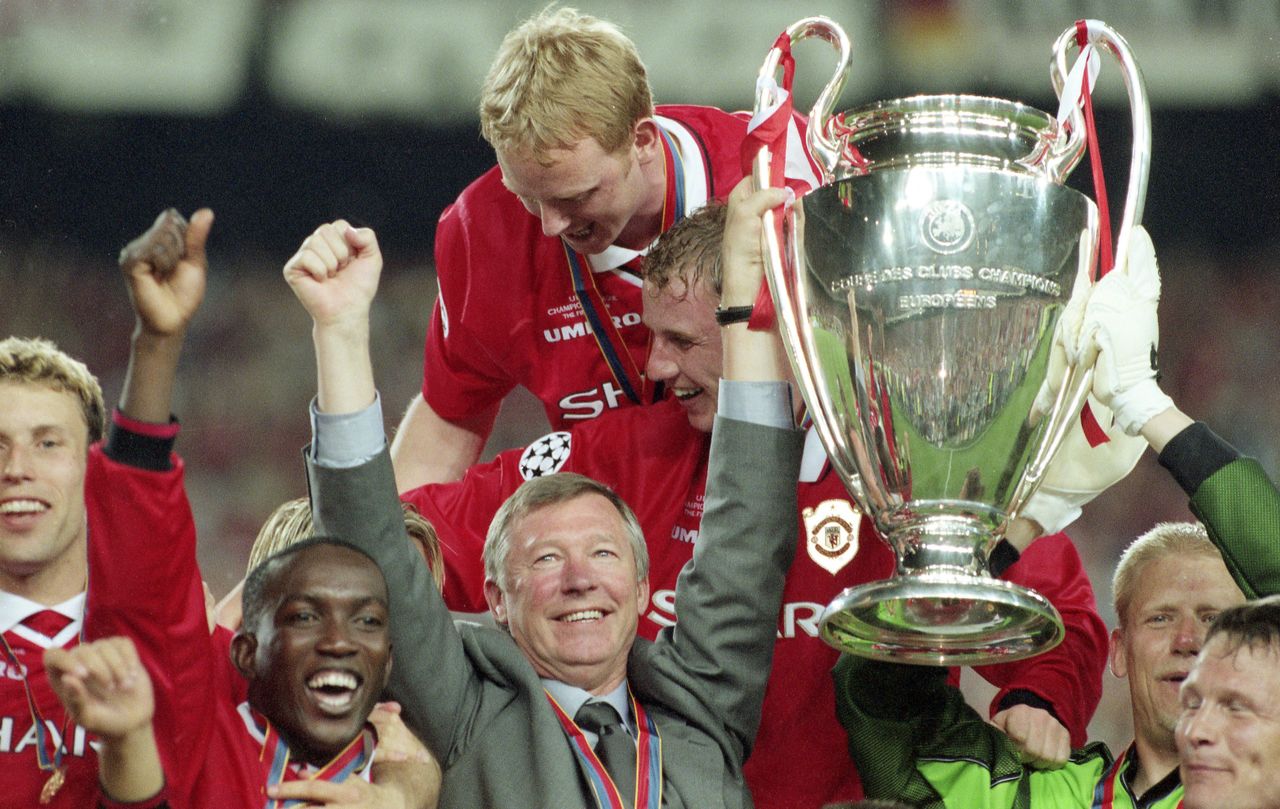 Manchester United manager Alex Ferguson lifts the Champions League trophy with his players after victory over Bayern Munich in the 1999 final at the Camp Nou in Barcelona, Spain