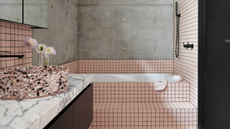 bathroom with pink tiled bath