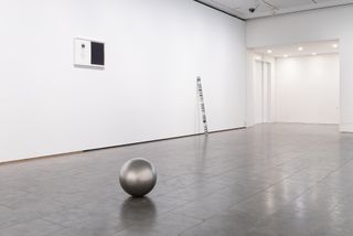 Spherical sculpture on floor of exhibition space