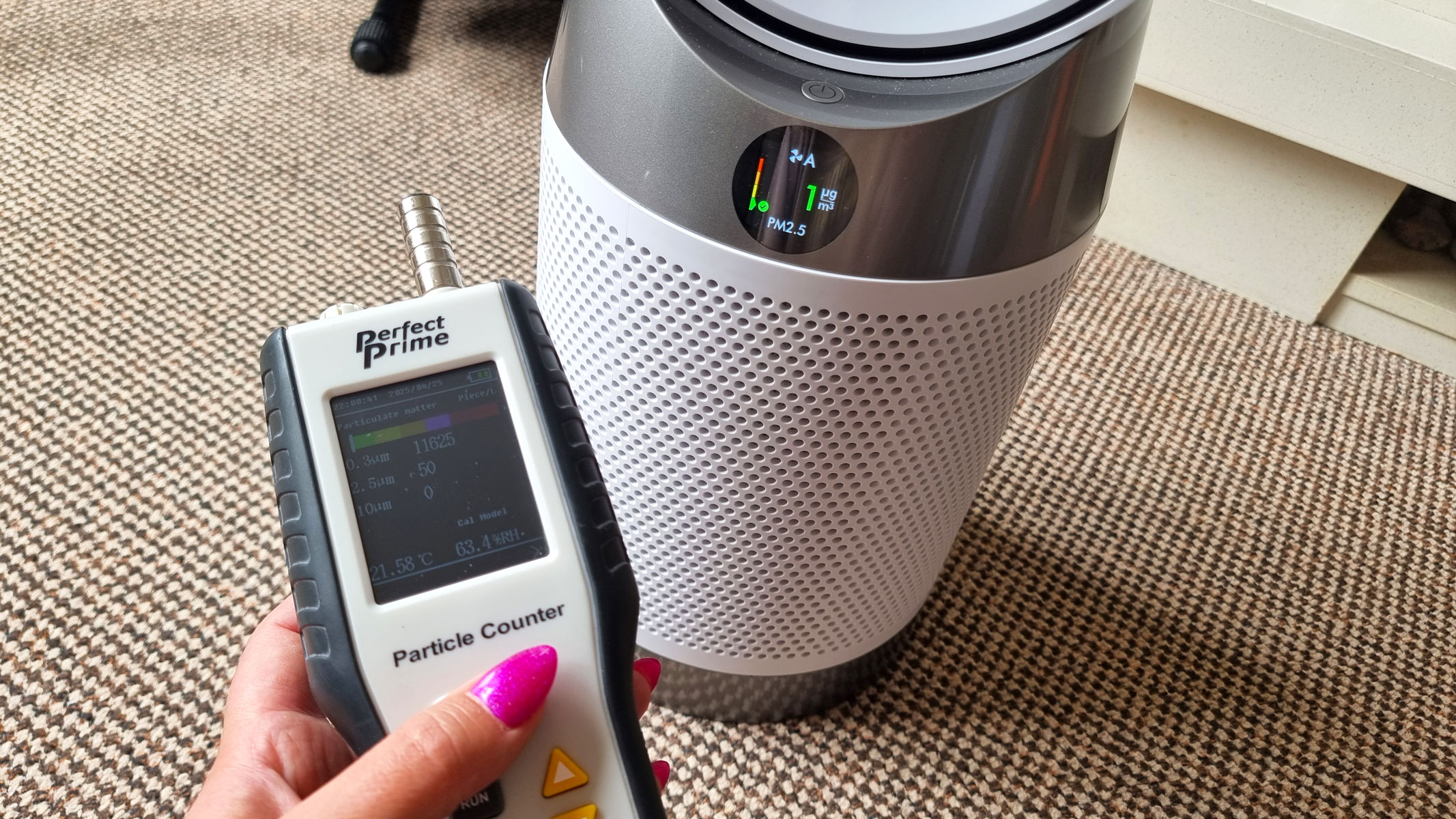 Dyson Purifier Cool PC1 being tested using an air particle monitor