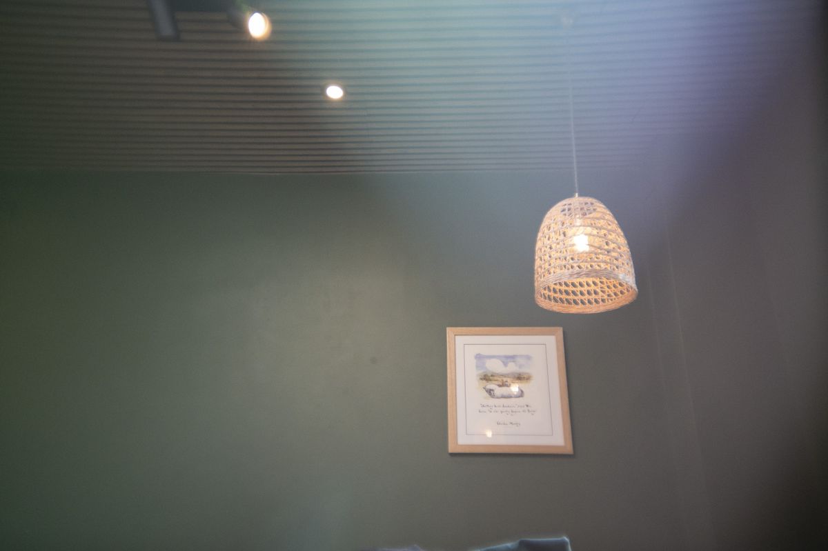 A lamp shade inside a cafe, with light leak effect