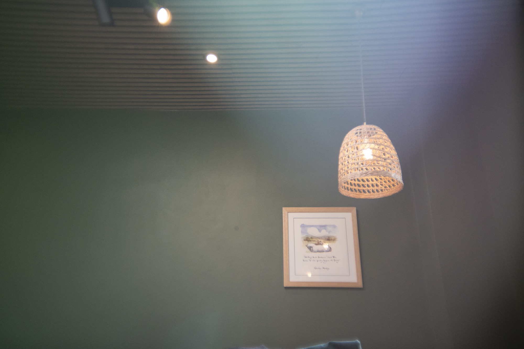 A lamp shade inside a cafe, with light leak effect