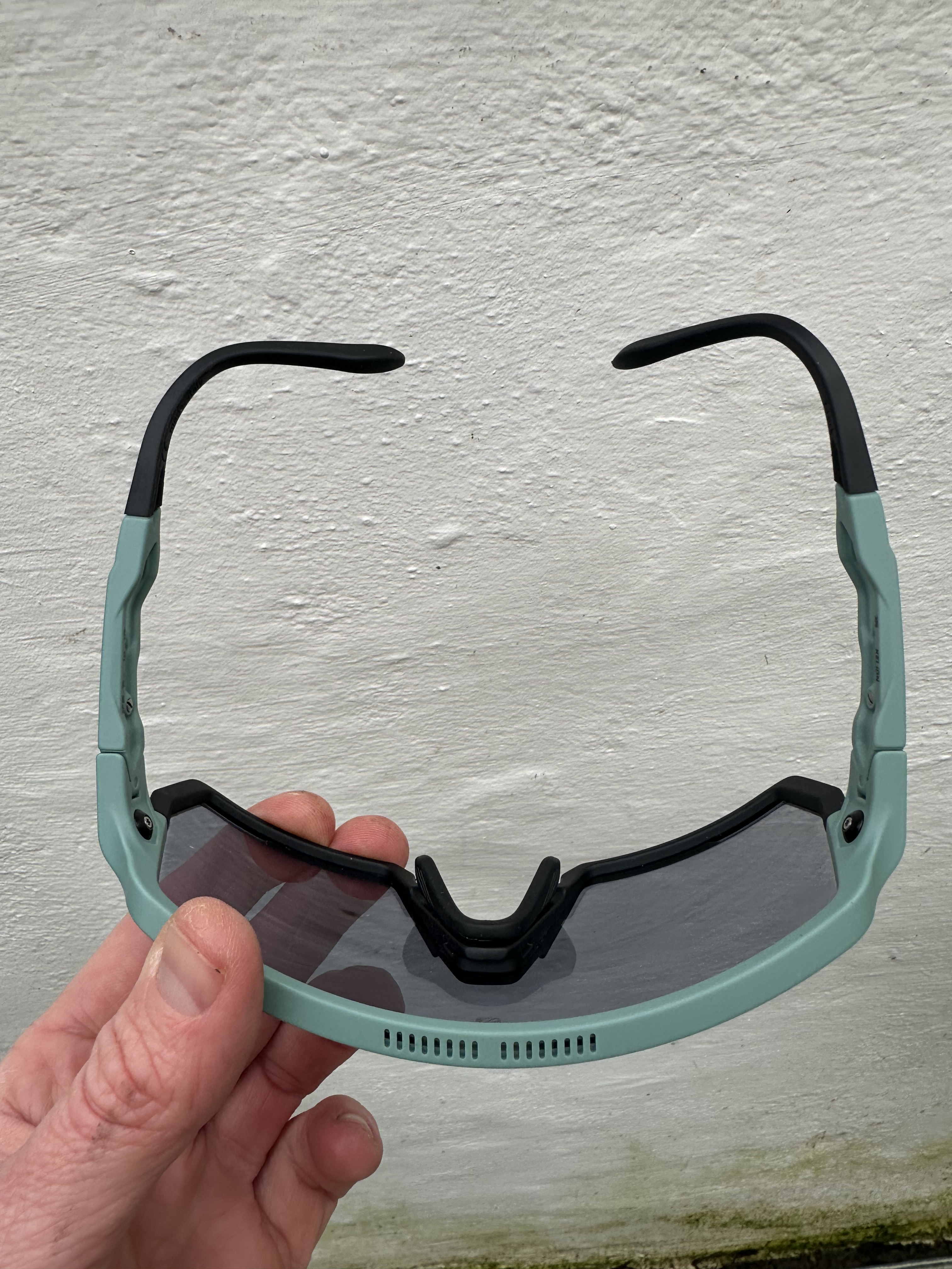 Sunglasses against a white wall