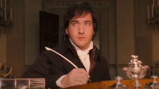 Matthew Macfadyen as Mr. Darcy holding a quill in his right hand in 2005's Pride and Prejudice.