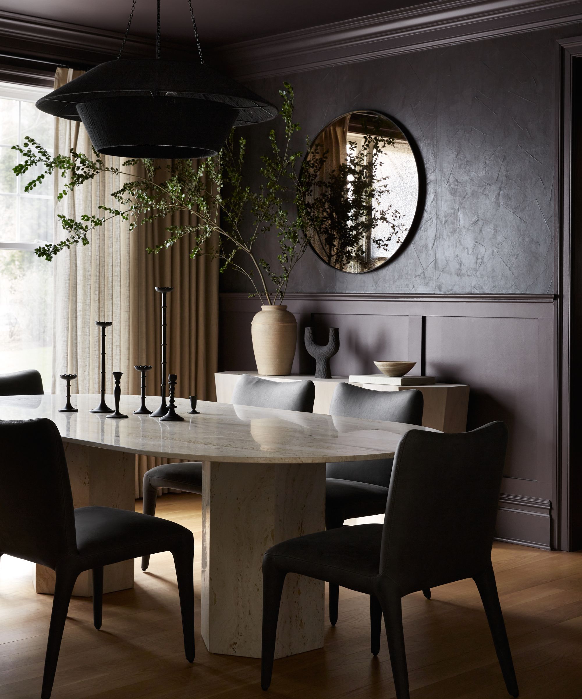 dining room with dark walls and oval white table